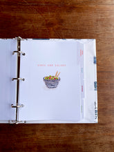 Load image into Gallery viewer, Open recipe book on a wooden surface with a page titled 'Sides and Salads'.