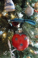 Load image into Gallery viewer, Hand painted Christmas ornament with a red background and dark scattered starburst design 