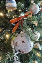 Load image into Gallery viewer, Hand painted Christmas ornament with tiny skaters on a snowy blue background