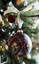 Load image into Gallery viewer, Decorative Christmas ornament with floral patterns on a tree