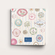 Load image into Gallery viewer, Patterned notebook with decorative plates on a white background