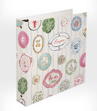 Load image into Gallery viewer, View from spine of recipe binder with decorative cover on a white background