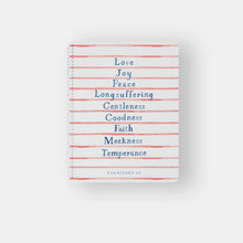 Load image into Gallery viewer, A spiral notebook with a white cover featuring red and blue stripes and text that lists the 'Fruit of the Spirit' from Galatians 5:22-23.